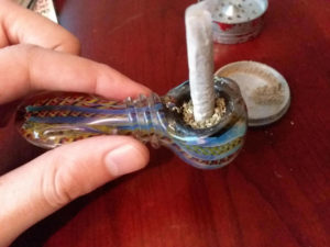 Placing Marijuana around joint